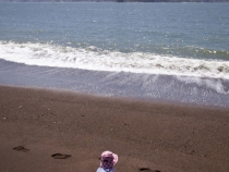 Lilia on the beach in Kirby Cove with the Golden Gate Bridge in the background