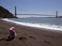 Lilia on the beach in Kirby Cove with the Golden Gate Bridge in the background