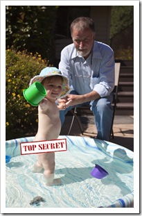 Lilia in the pool with Grandpa Greg
