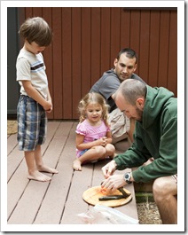 James, Ava and Che watching me clean the trout
