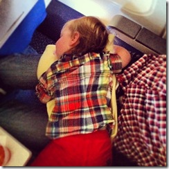 Lilia sleeping on Sam on the way between San Francisco and Denver