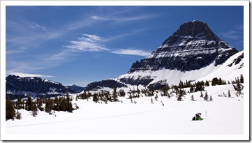 A skiier with Reynolds Mountain in the background