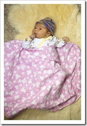 Lilia on Grandma Jenni's sheepskin