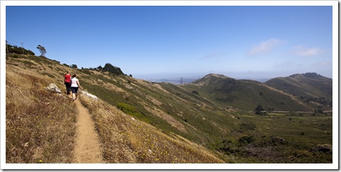 Margot and Lisa on the SCA Trail with the tips of the Golden Gate Bridge in the distance