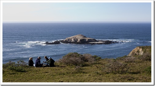 Hikers having lunch with Bird Rock in the background