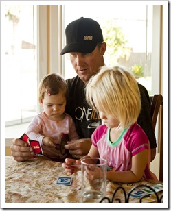 Lilia leaning how to play Uno from Sophia and Kevin