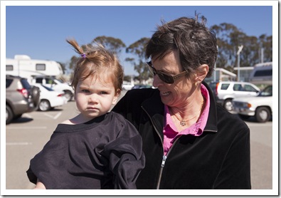 Jenni with Lilia in Dad's thermal shirt after getting soaking wet at East Beach
